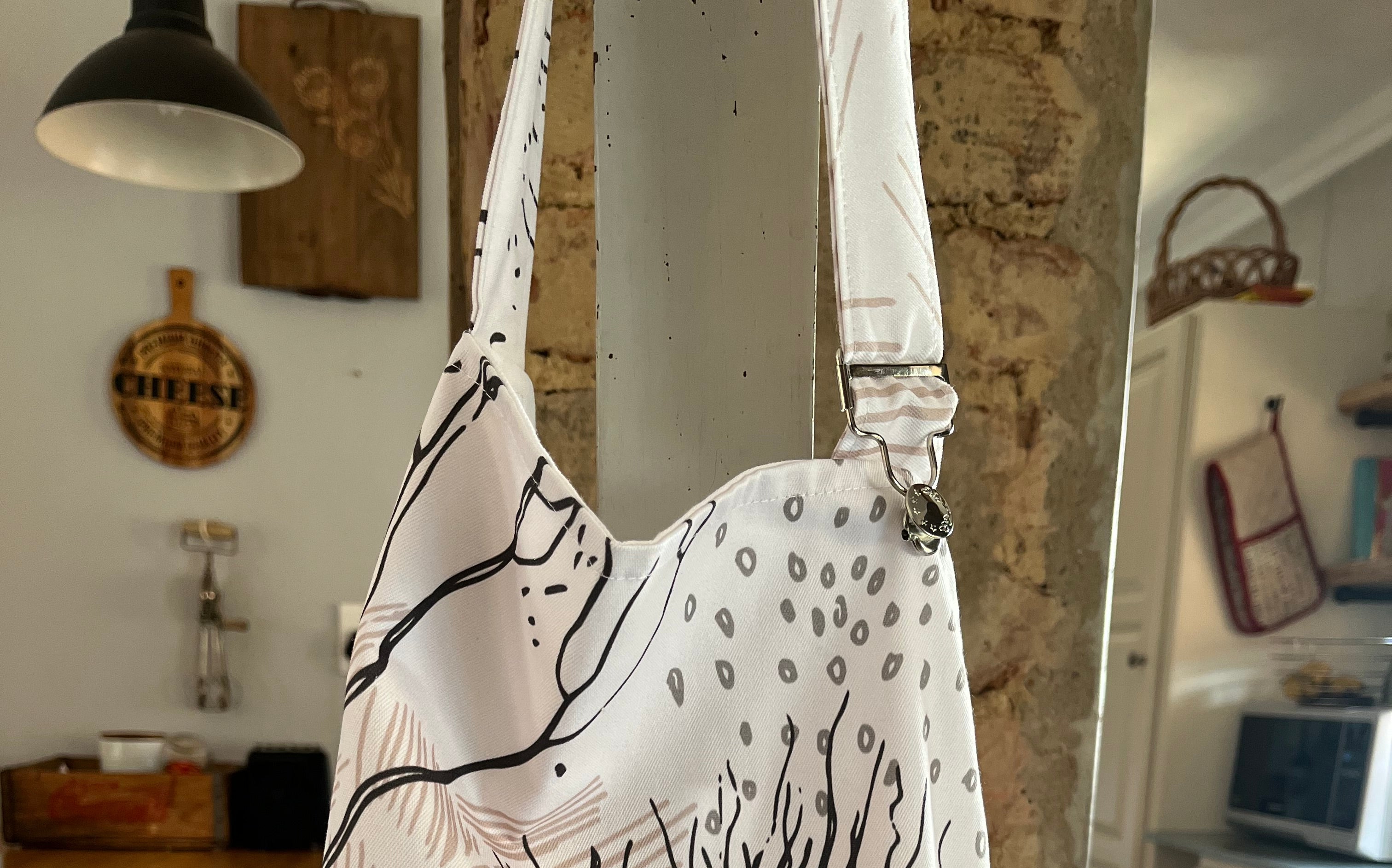 Apron with animal design hanging in kitchen